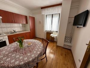 a kitchen with a table with a vase on it at Sunny Hill Apartment in Ilirska Bistrica