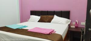a bedroom with a bed with two towels on it at HOTEL AYODHYA PAYING GUEST in Ayodhya