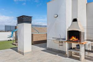 a outdoor pizza oven on a patio at Luxe Appartement Lo Pagan - San Pedro del Pinatar 850m from Beach Aldea Del Sol in San Pedro del Pinatar