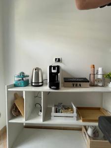 a white shelf with a coffee maker on it at Villa Maria Palese in Bari +31 photos