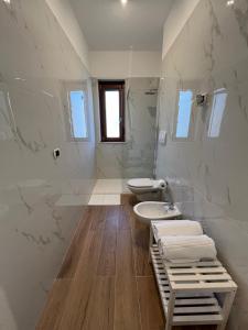 uma casa de banho branca com 2 WC e um lavatório em Villa Maria Palese em Bari