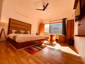 1 dormitorio con 1 cama y ventilador de techo en Solank Hotel & Cafe, en Amritsar