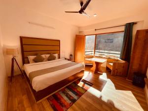 a bedroom with a large bed and a large window at Solank Hotel & Cafe in Amritsar