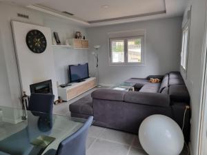 a living room with a couch and a glass table at Villa Lloret de Mar 6 Personas in Vidreres