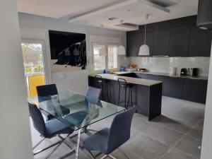 a kitchen with a glass table and some chairs at Villa Lloret de Mar 6 Personas in Vidreres +9 photos