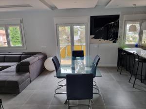 a living room with a glass table and a couch at Villa Lloret de Mar 6 Personas in Vidreres