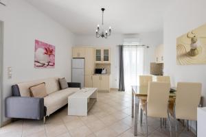 a living room with a couch and a table at Lydia's East Apartment in Aliki