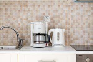 a kitchen counter with two coffins and a coffee maker at Lydia's East Apartment in Aliki