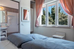 Postel nebo postele na pokoji v ubytování Albergo Cristina