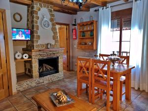 a living room with a table and a fireplace at VTAR San Isicio in Cazorla