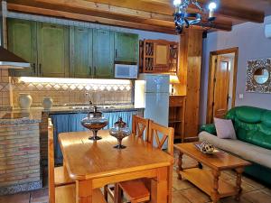 a kitchen and living room with a table and a couch at VTAR San Isicio in Cazorla