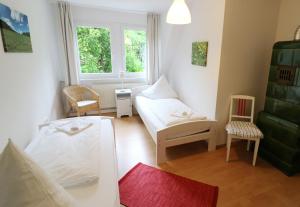 a living room with two beds and a window at Ferienwohnung im Haus Rhea am Südhang- Feldberg- Falkau in Vorderfalkau