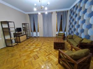 a living room with a couch and a table at Cozy Apartment In Old Town Kutaisi in Kutaisi
