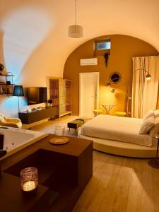 a bedroom with a large bed and a bathroom at Muralta Suite & Luxury Rooms in Altamura