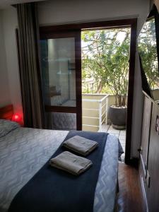 a bedroom with a bed with two towels on it at Pousada Monte Sião in Sao Paulo