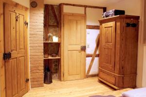 a room with an open door and a wooden cabinet at Ferienwohnung Sommerberg, Lenzkirch, 2 Schlafzimmer in Lenzkirch