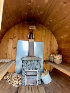 a woodburning stove in a wooden cabin at Zakątek u Basi in Frysztak