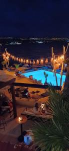 a view of a resort with a swimming pool at night at Apartment Gismondi in Ičići