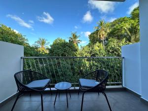 a balcony with two chairs and a table at Serene Sky Guest house in Thoddoo