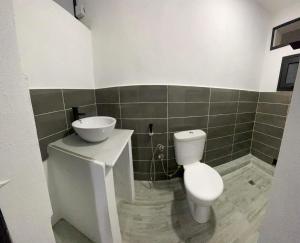 a bathroom with a toilet and a sink at Dream's Hôtel in Antsirabe