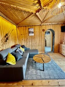 a living room with a couch and a table at Apartamenty Smrekowka in Zakopane