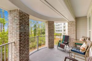a porch with a brick pillar and chairs on a balcony at Bahia Condos in Destin
