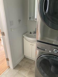 a kitchen with a washing machine and a sink at Rent My Studio in Powell River