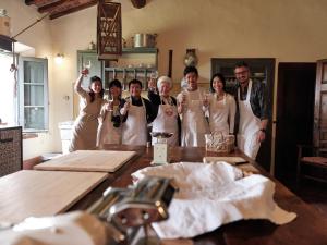 a group of people raising their champagne glasses at Pieve Marsina & Borgo Argenina in Monti di Sotto