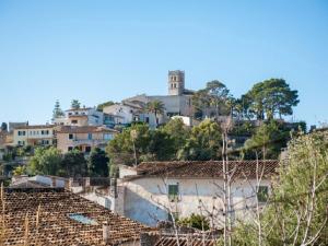 a group of houses on a hill with trees at Es Closet in El Port de la Selva
