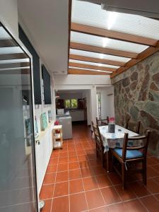 una cucina e una sala da pranzo con tavolo e sedie di Chalet Heliconia a Santa Cruz de Tenerife