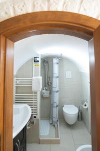 a small bathroom with a toilet and a sink at CASETTA CLOE house of charm and romance in Ceglie Messapica