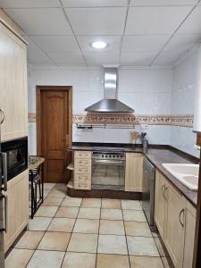 a kitchen with a stove and a sink at Ca Vicent in Estivella