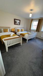 a bedroom with two beds in a room at San Pedro Lodge Sittingbourne in Kent