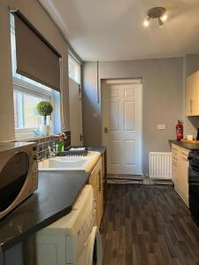 a kitchen with a sink and a stove at AA Tyne Apartments in Gateshead