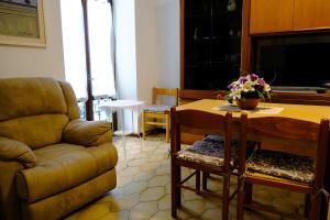 a living room with a couch and a table at La Casa dei Perci in Varenna +27 photos