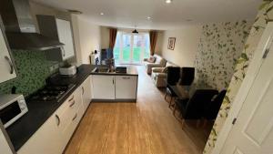 a kitchen and living room with a couch and a table at San Pedro- Frigate Lodge in Kent