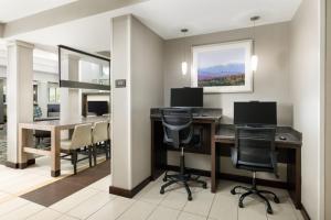 a living room with a desk with chairs and a table at Residence Inn Concord in Concord