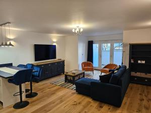 a living room with a couch and a table at Spacious, modern 2-bedroom flat in Clifton in Bristol
