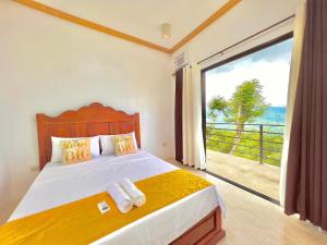 a bedroom with a bed with a view of the ocean at Mabini Sky View Resort in Cebu City