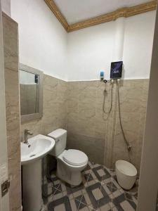 a bathroom with a toilet and a sink at Mabini Sky View Resort in Cebu City