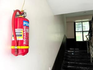 a fire extinguisher hanging on the wall of a building at HOTEL PRAKASH GUEST HOUSE ! Varanasi ! fully-Air-Conditioned hotel at prime location with off site Parking availability, near Kashi Vishwanath Temple, and Ganga ghat in Varanasi