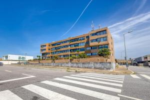 an empty street in front of a large building at Blue House by the Beach in Leça da Palmeira