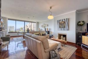 a living room with a couch and a fireplace at Blue House by the Beach in Leça da Palmeira