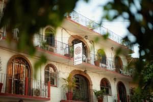 a building with balconies and a sign on it at Hotel Azteca in Puerto Vallarta