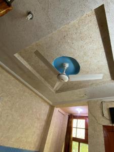 a ceiling fan is on the ceiling of a room at Zain Hotel Abbottabad in Abbottabad