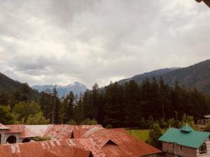 a view of a mountain range with houses and trees at Jagdish Guest House in Bhiwāni
