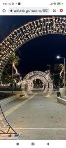 a lit up archway in a parking lot at night at Λαμπερό Διαμέρισμα 1 in Thessaloniki