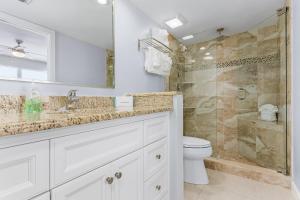 a bathroom with a sink and a toilet and a shower at Fantastic Gulf Front Condo on the North End of the Island - Beach Villas # 504 condo in Fort Myers Beach