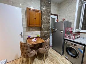 a small kitchen with a table and a refrigerator at Luxury apartment Downtown Cairo in Cairo