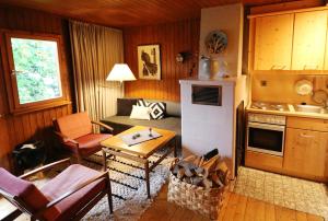 a kitchen and living room with a couch and a table at Ferienhaus Ahorn, 3 Schlafzimmer, Todtnauberg in Todtnauberg